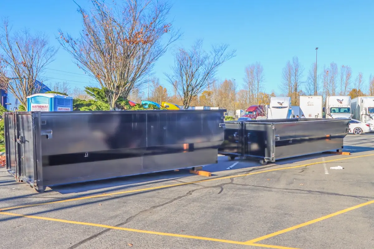 Professional dumpster rental service with roll-off container on residential driveway in Laurinburg